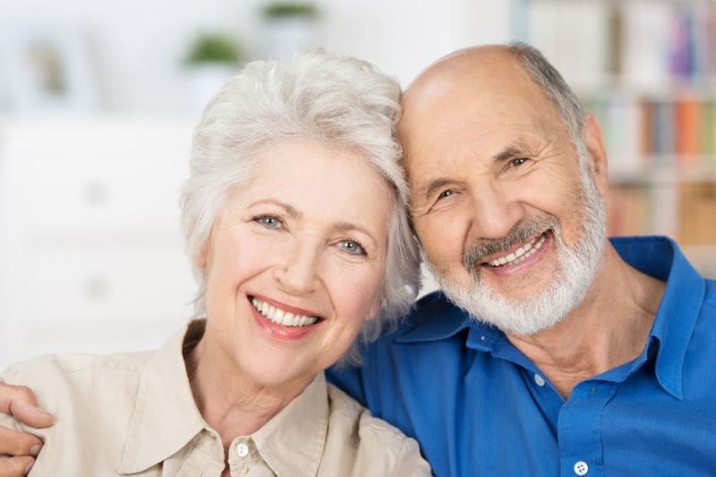 Older couple smiling | dental implants Lexington ma