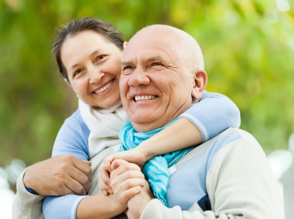 dental implants in Lexington MA | Elderly couple smiling.