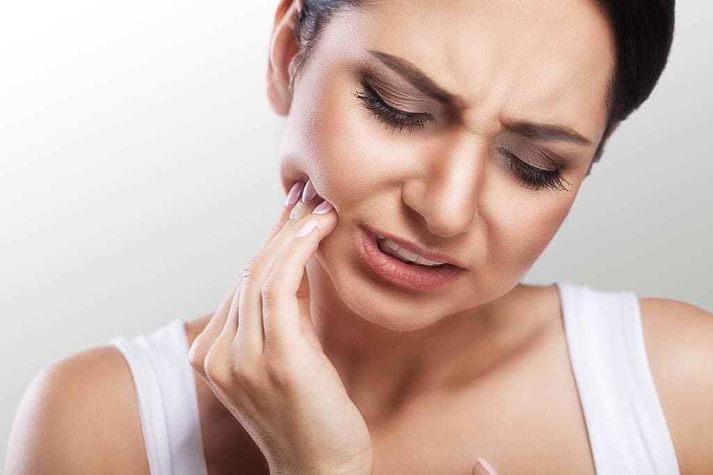 emergency dental care | woman feeling tooth pain.